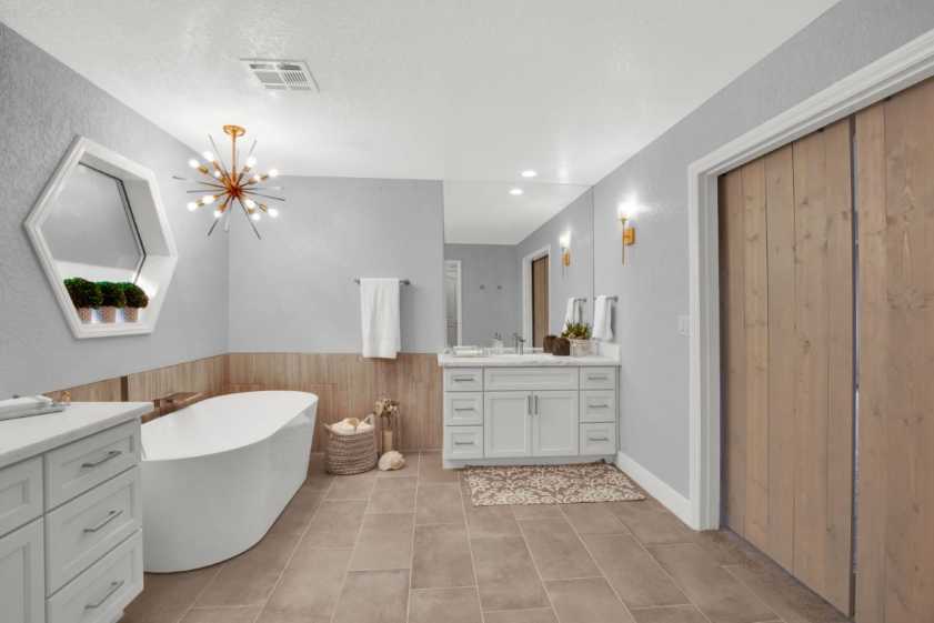 12 bathroom with tub and modern light fixture
