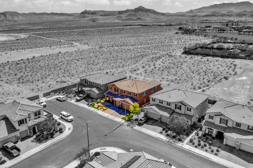Las Vegas drone photo of highlighted house drone photo of house in desert with house highlighted and the rest of the picture is black and white.