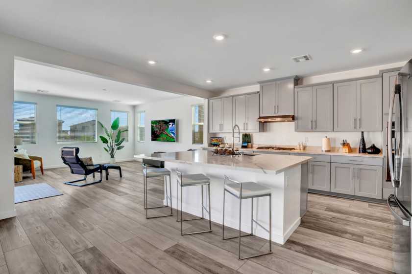Kitchen in Las Vegas home kitchen with three stools and hardwood floors