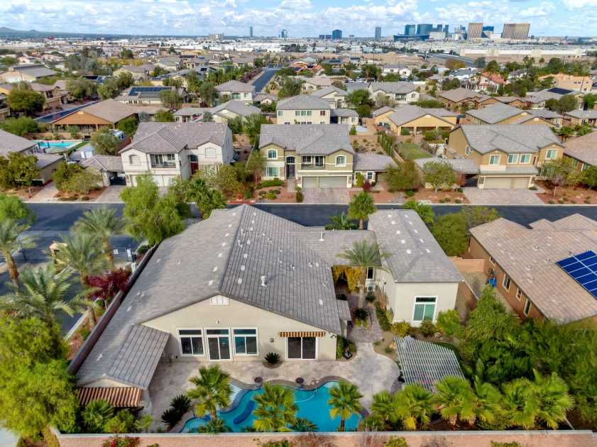 drone photo with pool and Las Vegas strip drone photo of backyard with pool and view of Las Vegas strip in the horizon